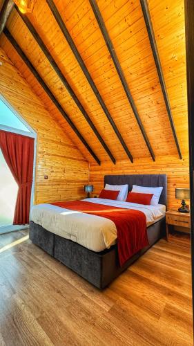 a bedroom with a large bed in a wooden ceiling at Luna Home Club in Samandağı