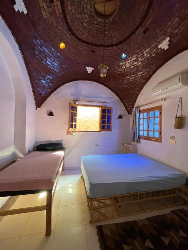 a bedroom with a bed with a wooden ceiling at Dream house in Luxor