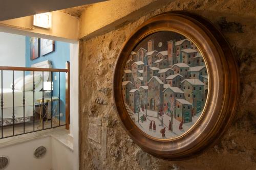 a painting of a city on the wall of a building at Tramonto sul Lago in Passignano sul Trasimeno
