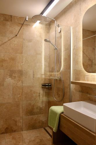 a bathroom with a shower and a sink at Pension Norika in Saalbach-Hinterglemm