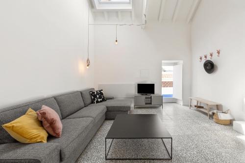 a living room with a couch and a table at Arneiro Garden House - Country Retreat with BioPool in Alenquer
