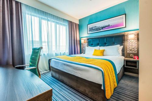 a hotel room with a bed and a window at Leonardo Hotel Brighton in Brighton & Hove