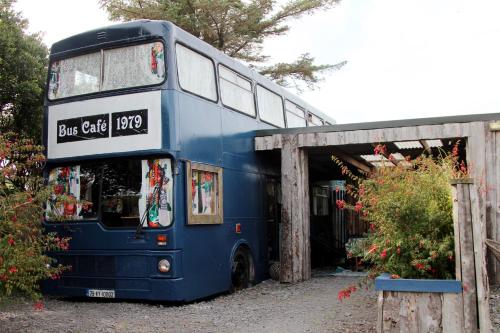 a blue double decker bus parked next to a building at Valentia Island Escape in Valentia Island