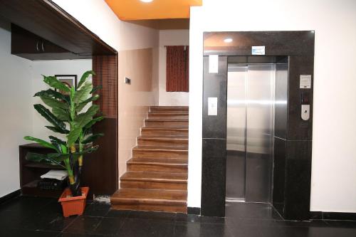 a hallway with a elevator and a stair case at Malaysia inn in Chennai