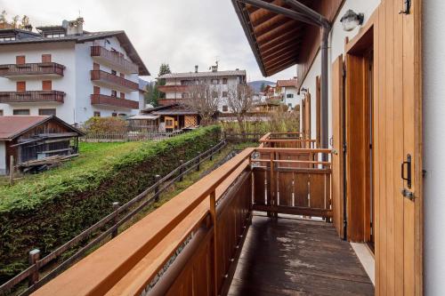 a balcony of a building with a wooden railing at Residence Malibu Appartamento 7 in Falcade