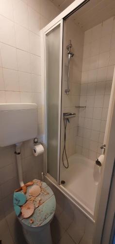 a bathroom with a shower and a toilet with leaves on it at Perfect Appartement - Dichtbij Zee en Natuur in Vlissingen