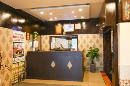 a restaurant with a counter with a potted plant at Malaysia inn in Chennai