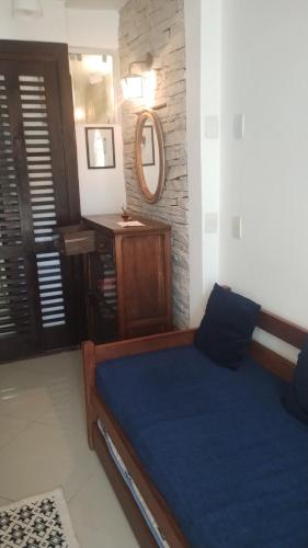 a bedroom with a bed and a mirror and a window at Loft Geribá in Búzios