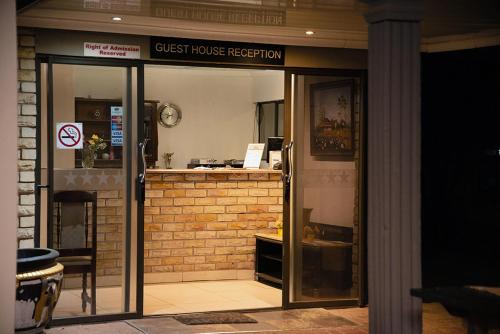 an entrance to a restaurant with a glass door at Gold Guest & Conference in Welkom