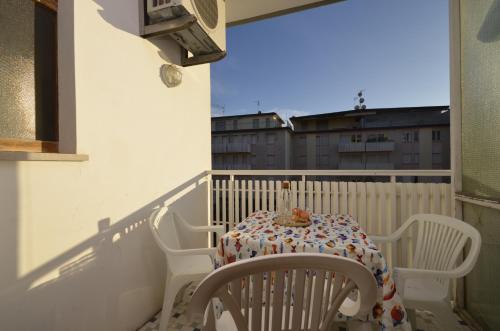 a balcony with a table and chairs on a balcony at Appartamenti Foyer in Bibione