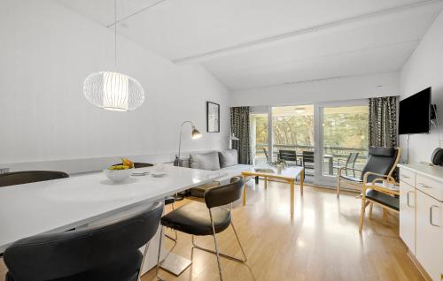 a kitchen and living room with a table and chairs at 1 Bedroom Lovely Apartment In Nexø in Neksø