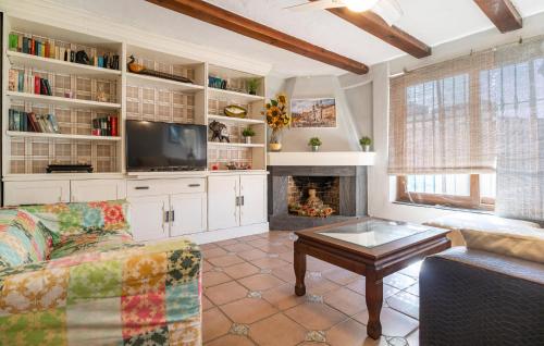 a living room with a couch and a fireplace at Stunning Home In Chiclana De La Fronter in Chiclana de la Frontera