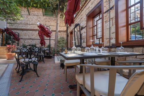 a restaurant with tables and chairs on a patio at Belmondo Suites Old Town Antalya in Antalya