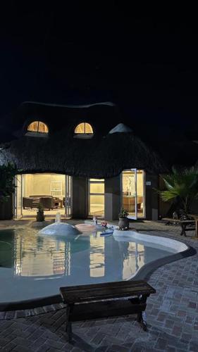 a swimming pool with a bench in front of a building at STAY In TEHAMA in Cape Town
