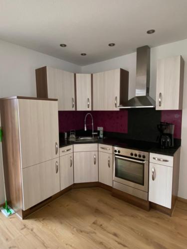 a kitchen with white cabinets and a stainless steel appliance at Ferienwohnung Winkler in Rothenburg ob der Tauber