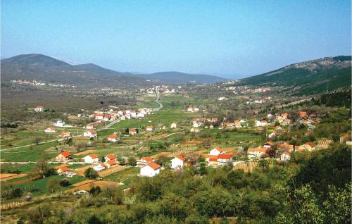 a small town in a valley with mountains at Nice Home In Zrnovnica-Split With Sauna in Cista Provo
