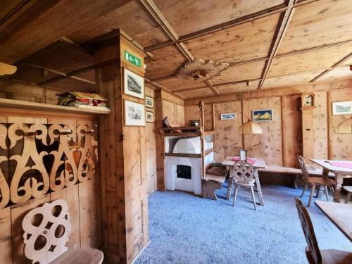 a room with wooden walls and a table and chairs at Hotel Dolomites Inn in Canazei