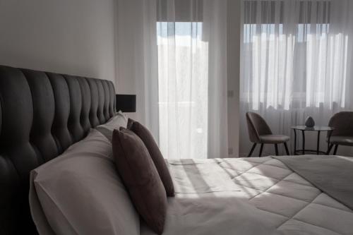 a bedroom with a large bed with a large headboard at La Maison Foggia in Foggia
