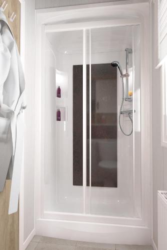 a shower with a glass door in a bathroom at Lochgilphead Caravan Park in Lochgilphead