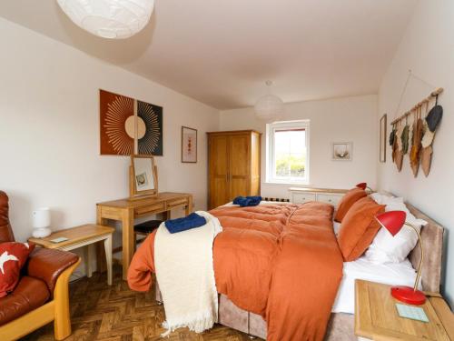 a bedroom with a large bed and a couch at Tirlaggan Úr in Oban