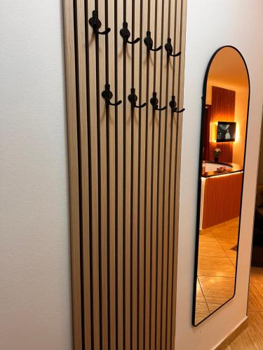 a mirror and a radiator next to a wall at Legacy Loft 1 in Durrës