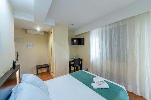 a bedroom with a bed with towels on it at Hotel Monasterio Granada - Adults Only in Granada
