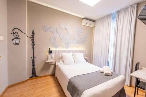 a hotel room with a bed and a desk at Hotel Monasterio Granada - Adults Only in Granada