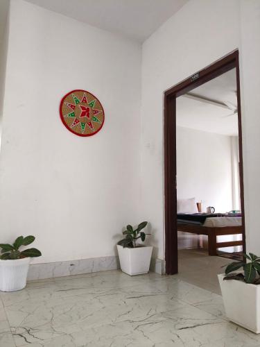 a room with a mirror and a clock on the wall at Shivaji Inn Kaziranga in Kāziranga