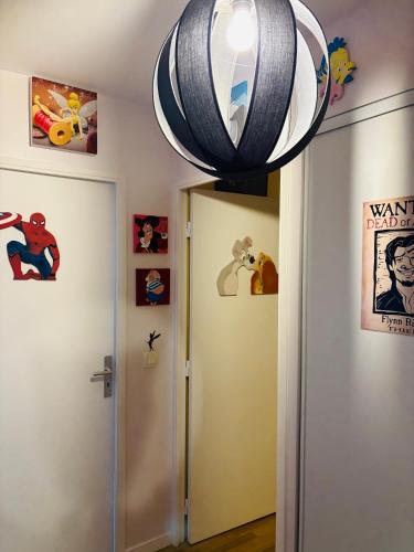 a room with a door and a lamp above it at THE ENCHANTED HOUSE ( 15 min walk to Disney) in Serris
