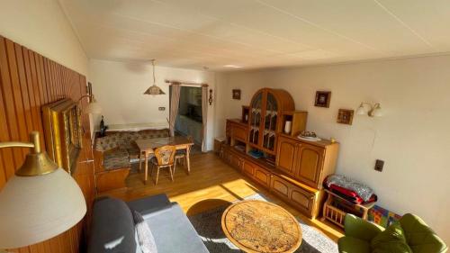 a living room with a couch and a table at Klassiek appartement 300meter van duinen en strand in Vlissingen