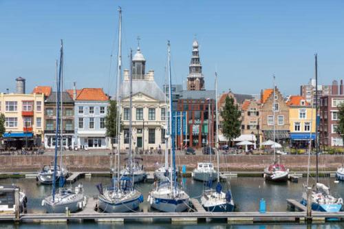 a group of boats are docked in a harbor at Klassiek appartement 300meter van duinen en strand in Vlissingen