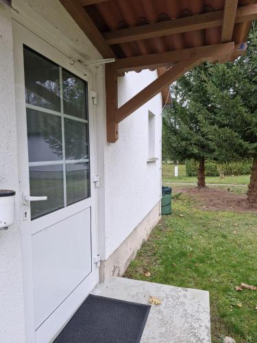 a white door on a house with a porch at Landidyll Monte Gristow in Mesekenhagen