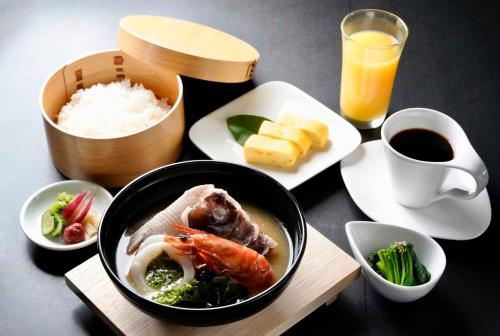 a table with a bowl of food and a plate of rice at GranVista角島 in Oyama