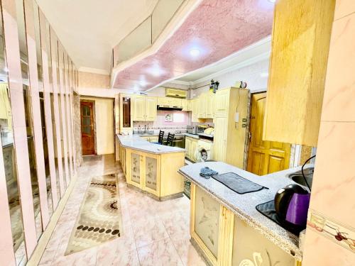 a large kitchen with wooden cabinets and counters at Nile and island in Cairo
