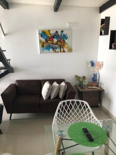 a living room with a couch and a glass table at CIC Apartamento amoblado Mirador del Sinú in Montería