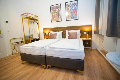 a bedroom with a large bed in a room at Private CENTRAL Vienna I Self Check In in Vienna