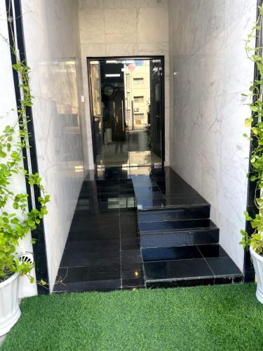 a hallway of a building with stairs and plants at Ista Vacation Homes Rental LLC in Dubai