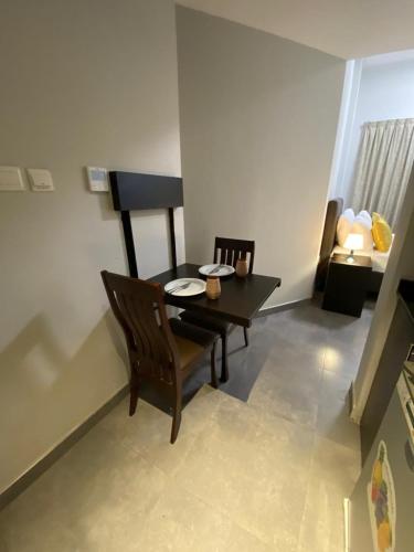 a dining room with a table and a chair at Ista Vacation Homes Rental LLC in Dubai