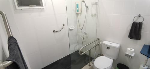 a white bathroom with a shower and a toilet at Bassara House 2 bedroom in Koh Lone