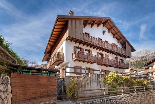 a house with balconies on the side of it at Residence Malibu Appartamento 4 in Falcade