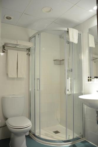 a bathroom with a shower and a toilet and a sink at Original Domino House in Valencia