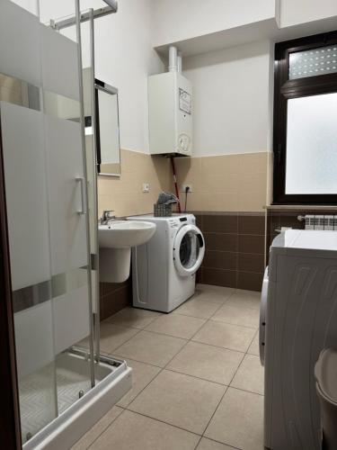 a bathroom with a washing machine and a sink at casa Manthone - LuxRental Apartments in Pescara