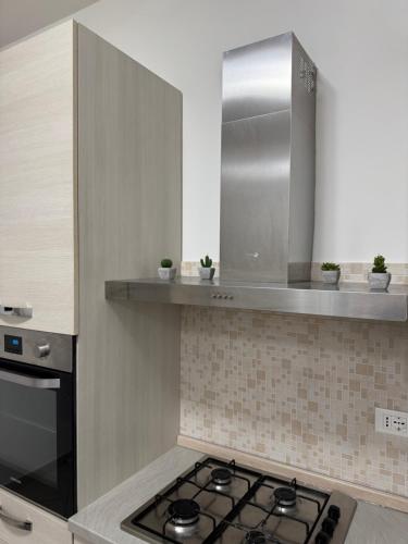 a kitchen with a stove top in a kitchen at casa Manthone - LuxRental Apartments in Pescara