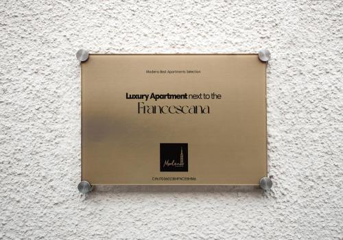 a sign on the side of a wall at Luxury Apartment next to the Francescana in Modena