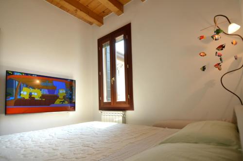 a white bedroom with a bed and a window at Airy & panoramic with terrace, 2 minutes from the sea in Venice-Lido
