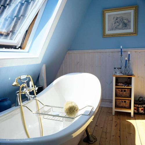a bathroom with a white bath tub in a attic at Villa Lilla Pärla in Virserum