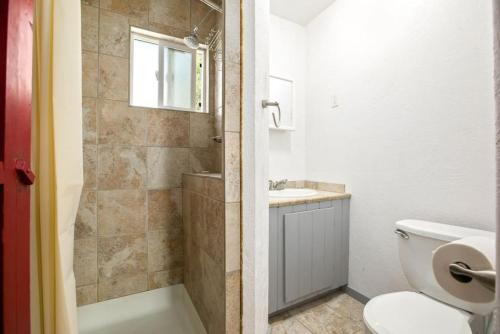 a bathroom with a shower and a toilet and a sink at Bo360 Bungalow with Hot Tub and Sauna in Billings
