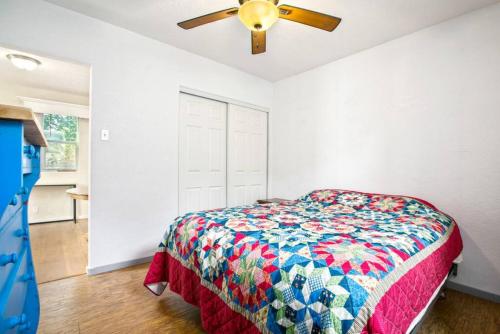a bedroom with a bed and a ceiling fan at Bo360 Bungalow with Hot Tub and Sauna in Billings