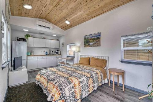 a bedroom with a bed and a kitchen at Bo360 Tiny House Unique Country Retreat with Hot Tub in Puyallup