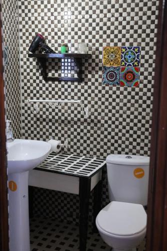 a bathroom with a toilet and a sink at Dar Sababa in Chefchaouene